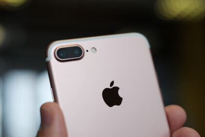 A hand holding an iPhone 7+ phone